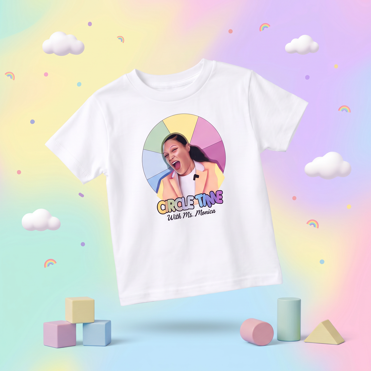 White vintage Circle Time with Ms. Monica toddler tee on a pastel rainbow background